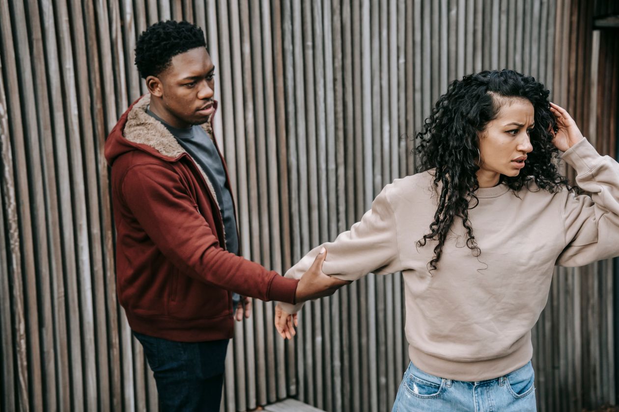 A man gently reaching out to reconnect with his upset partner