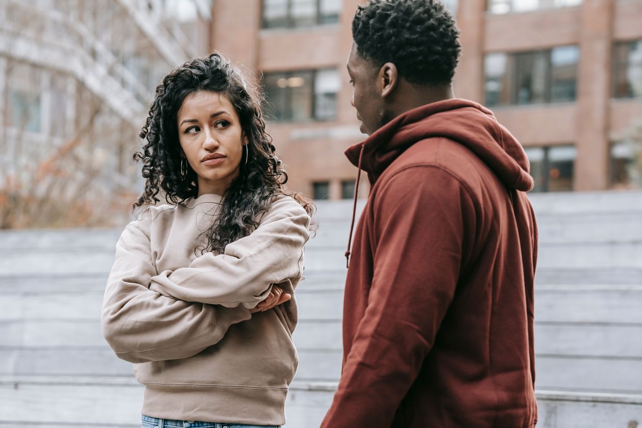 A couple in a tense disagreement on the street