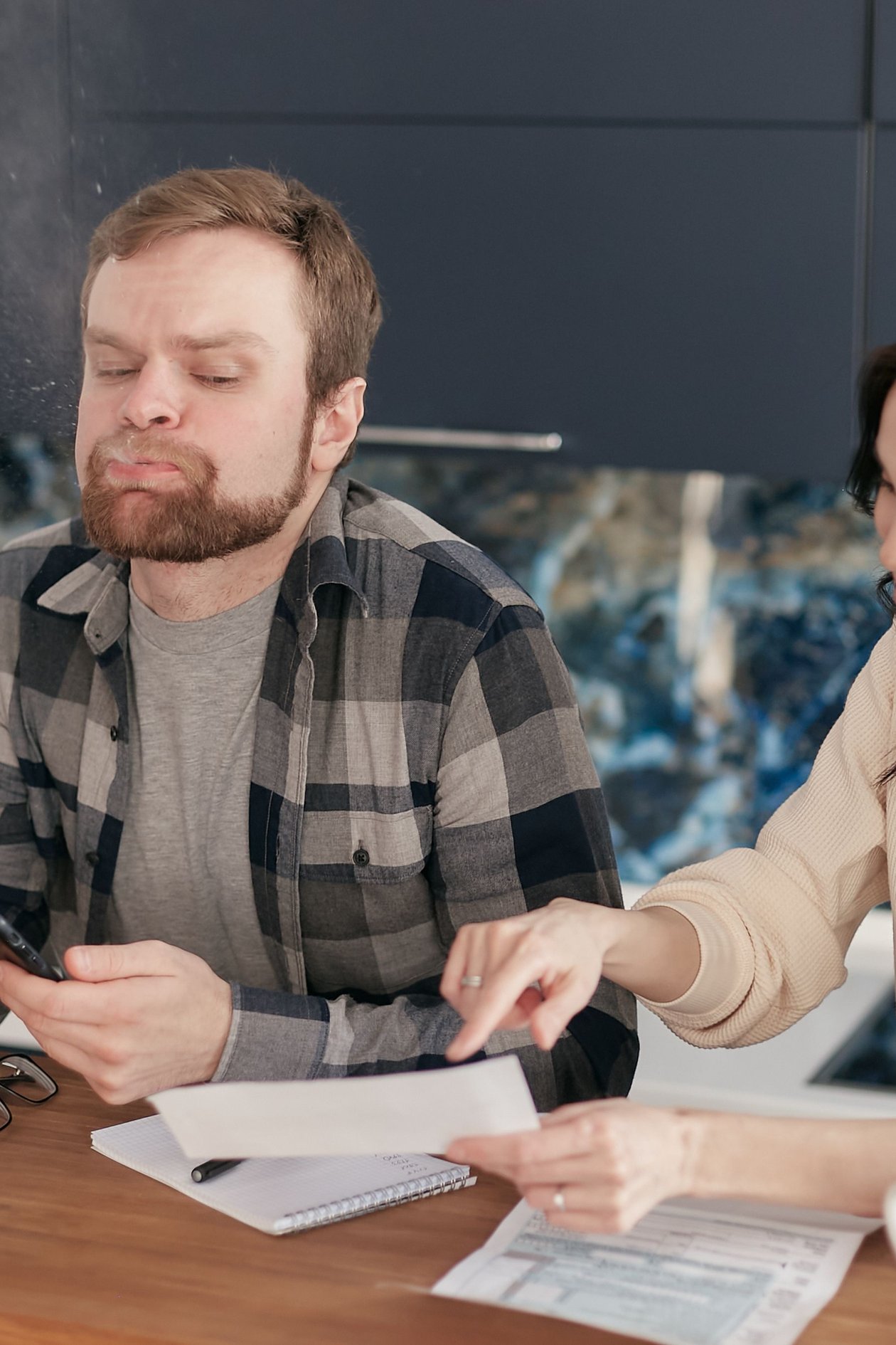 A couple looking over bills and financial documents together at a table