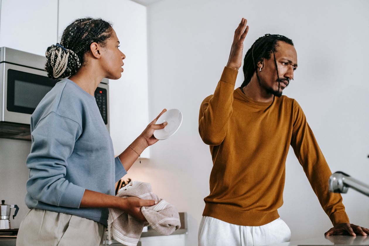 A man mid-argument, visibly upset and raising his hand while speaking